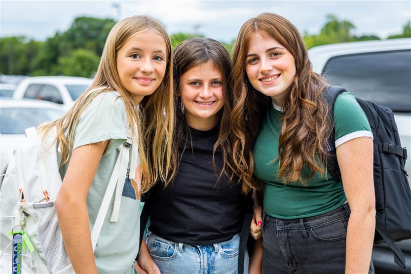 Three girls smile